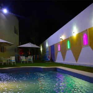 a swimming pool in front of a building at night at Charming Villa in Monastir with Private Pool in Monastir
