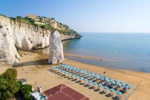 an overhead view of a beach with a bunch of umbrellas at Charming House in Vieste with Shared Pool and Terrace in Vieste