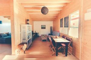 a room with a table and chairs in a cabin at Charming house in Cañamero with pool and mountain view in Cañamero