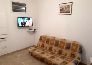 a living room with a couch and a flat screen tv at Maison de 2 chambres avec jardin clos a Morne A l'Eau a 2 km de la plage in Morne-à-lʼEau