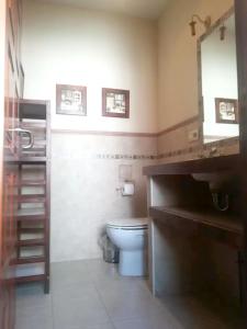 a bathroom with a toilet and a sink and a mirror at Charming house in Úbeda + pool in Úbeda +4 photos