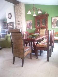 a dining room with a wooden table and chairs at 2 bedrooms property with shared pool enclosed garden and wifi at Ubeda in Úbeda