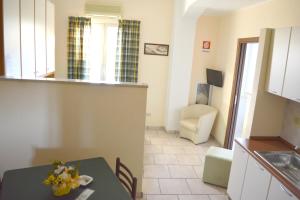 a kitchen and a dining room with a table in a room at Studio at Reggio Calabria 2 km away from the beach in Reggio di Calabria