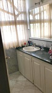 a bathroom with a sink and a mirror at One bedroom apartement with sea view jacuzzi and furnished terrace at Boca Chica in Boca Chica