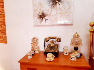 a table with a telephone and other items on it at 4 bedrooms house with city view balcony and wifi at Illar in Illar