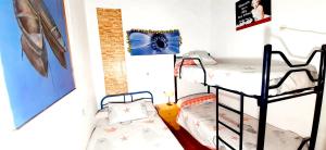 a room with two bunk beds in a room at 4 bedrooms house with city view balcony and wifi at Illar in Illar