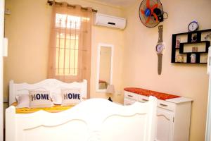 a bedroom with a white bed with two pillows at Spacious apartment in Pereybere, 100 m² with shared pool in Pereybere
