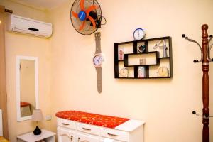 a room with clocks on the wall and a bench at Spacious apartment in Pereybere, 100 m² with shared pool in Pereybere +9 photos