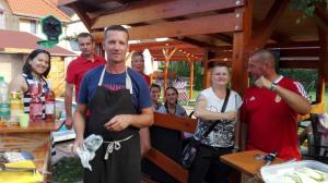 a man in an apron standing in front of a group of people at Patrícia Panzió in Bük +69 photos