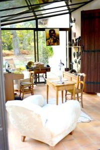 a living room with a white couch and a table at Maison de 4 chambres avec piscine privee jacuzzi et jardin clos a Callen in Callen