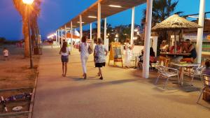 a group of people walking on the beach at night at Maison accueillante à Leucate avec jardin et terrasse in Leucate