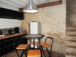 a kitchen with a table and chairs and a refrigerator at Maison de 2 chambres avec wifi a Chalo Saint Mars in Châlo-Saint-Mars