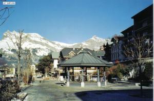 a building with a gazebo in front of a mountain at Studio chaleureux à Saint-Gervais-les-Bains, 23m², vue montagne in Saint-Gervais-les-Bains