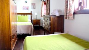 a small bedroom with two beds and a dresser at 2 bedrooms appartement with furnished terrace and wifi at Santa Cruz de Tenerife Canarias 5 km away from the beach in Los Silos