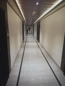 an empty corridor in an office building with a long aisle at Rudra Shelter International Hotel in Vasai