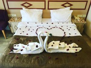 a bed with two swans made out of towels at Sultan Palace Hotel in Istanbul
