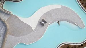 an overhead view of a person standing in front of a wave at Summer Senses Luxury Resort in Logaras