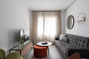 a living room with a couch and a table at Royal Flats in Las Palmas de Gran Canaria