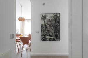 a white room with a picture of palm trees on the wall at Royal Flats in Las Palmas de Gran Canaria