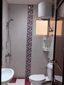 a bathroom with a toilet and a sink at Deyala Serviced Apartments 1 in Riyadh