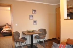 a room with a table and two chairs and a bed at Ursprung Apartments in Rostock