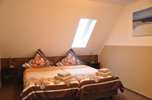 a bedroom with a bed with pillows and a window at Ursprung Apartments in Rostock +52 photos