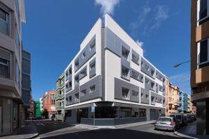 a tall white building on a city street at Royal Flats in Las Palmas de Gran Canaria