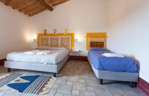 a bedroom with two beds and a window at Poderi in Chianti in Tavarnelle in Val di Pesa +36 photos