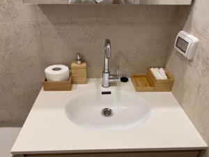 a bathroom counter with a sink and a toilet at daniel hotel beach view boutique apt in Herzliya
