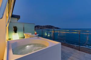a bath tub on a balcony with a view of the ocean at Hotel Maritim in Roses