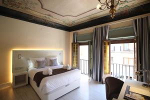 a bedroom with a bed with two teddy bears on it at Palacio La Floresta in Segovia