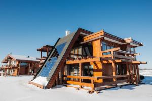 a house in the snow with a slide at Gorki Golf Resort in Gorki