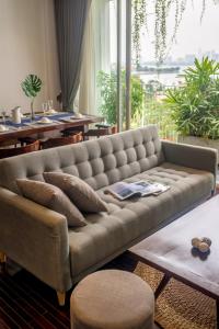 a living room with a couch and a table at Pegasy Suites Lakeside in Hanoi