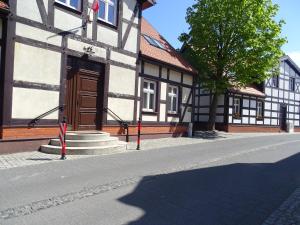 a building with a wooden door on a street at Apartamenty w Ustce in Ustka