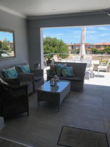 a living room with couches and a table at Chartwell House in Velddrif