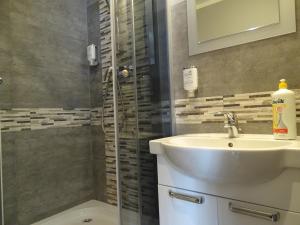 a bathroom with a sink and a shower at Apartamenty w Ustce in Ustka +46 photos