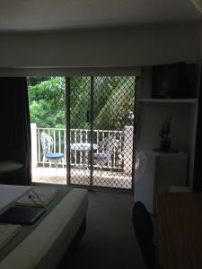 a room with a bed and a window at Paravista Motel in Darwin