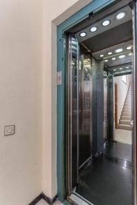 an elevator in a building with a glass door at Studio near the Sea and City in Las Palmas de Gran Canaria