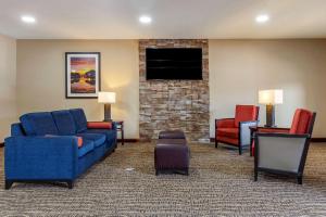 a living room with a couch and chairs and a tv at Comfort Inn Smithfield near I-95 in Smithfield