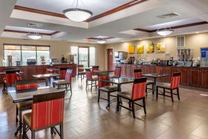 a dining room with tables and chairs in a restaurant at Comfort Inn Smithfield near I-95 in Smithfield