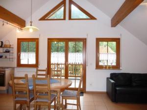 a living room with a table and chairs and a couch at Haus Sum in Oberwolfach