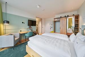 Postel nebo postele na pokoji v ubytování Hotel Federwerk