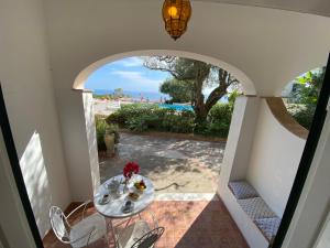 a room with a table and a view of the ocean at Residence Terra Rossa Taormina in Taormina