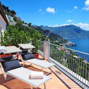 einen Balkon mit Stühlen und Blick auf das Wasser in der Unterkunft Amalfi Blu Retreat in Amalfi