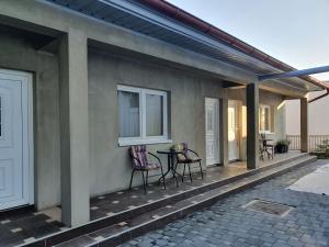 a patio with chairs and a table on a house at Apartman "MILLAN" in Prijedor