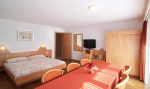 sypialnia z łóżkiem, stołem i krzesłami w obiekcie Hotel Eden No. 7 w mieście Saas-Fee