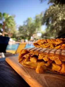 a piece of food on a wooden cutting board at Le Relais De Marrakech in Marrakech