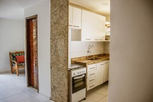 A kitchen or kitchenette at Tamandare Residence