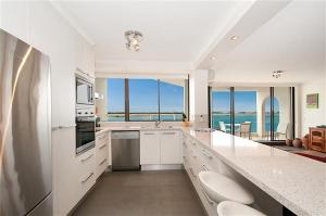 a large white kitchen with a view of the ocean at Beaconlea in Gold Coast