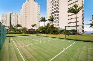 a tennis court in a city with tall buildings at Beaconlea in Gold Coast